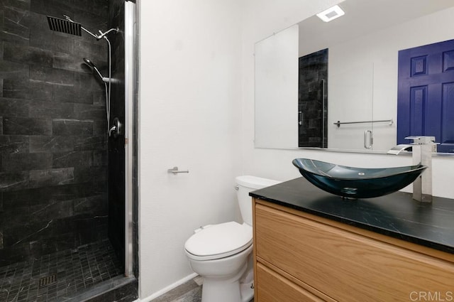 bathroom featuring visible vents, toilet, a stall shower, and vanity