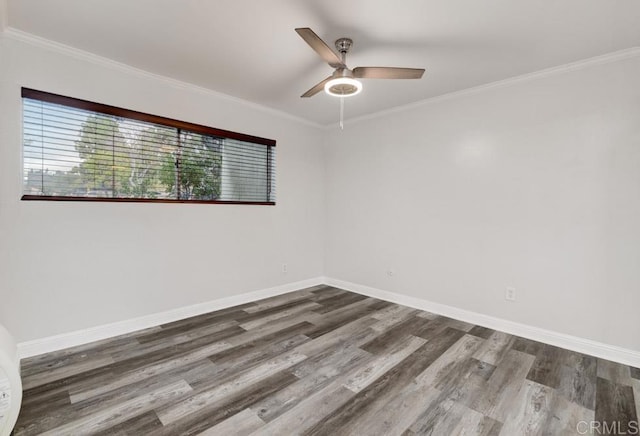 unfurnished room featuring a ceiling fan, crown molding, baseboards, and dark wood-style flooring