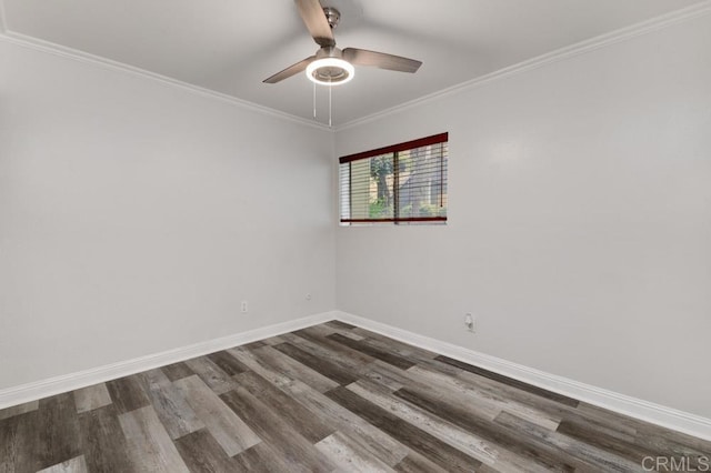 spare room featuring a ceiling fan, dark wood-type flooring, crown molding, and baseboards