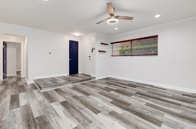 unfurnished room featuring ceiling fan, baseboards, and wood finished floors