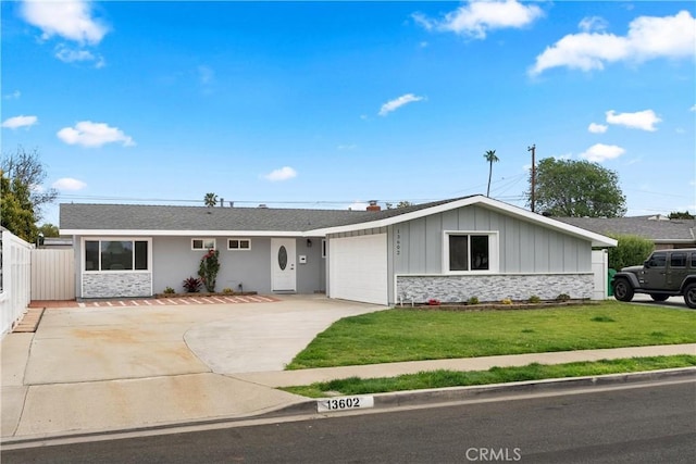 single story home with board and batten siding, fence, a front yard, a garage, and driveway