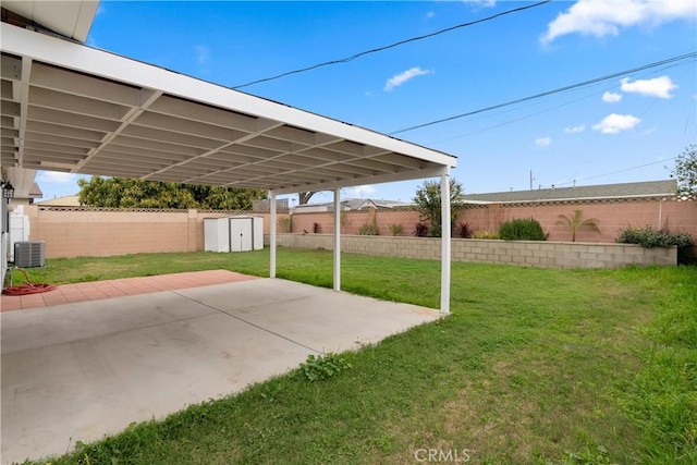 view of yard with a fenced backyard, a shed, central air condition unit, and an outdoor structure