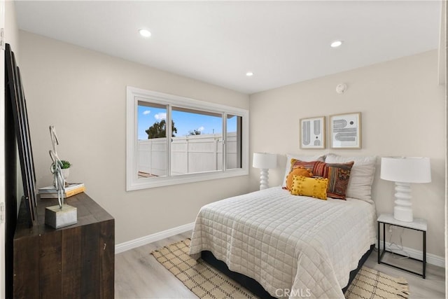 bedroom featuring recessed lighting, baseboards, and light wood-style flooring