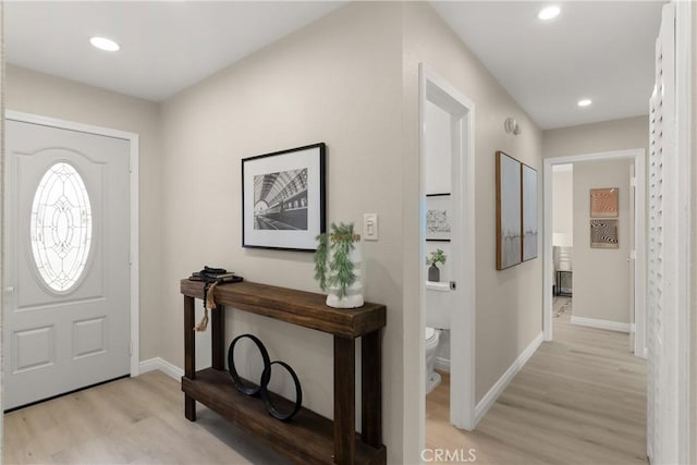 foyer with recessed lighting, light wood-type flooring, and baseboards