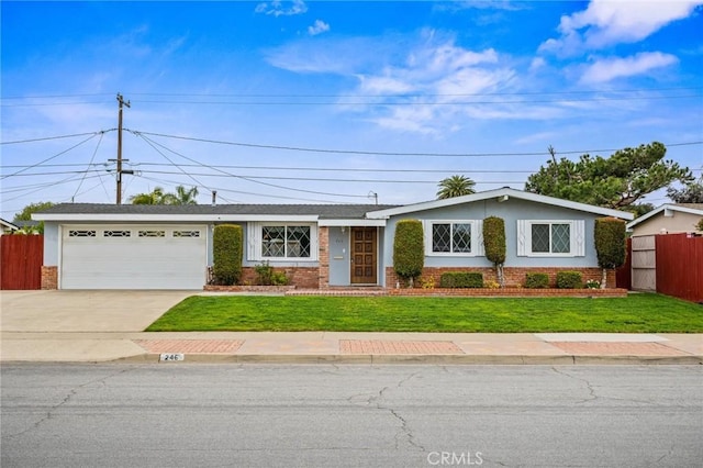 ranch-style house with brick siding, an attached garage, fence, driveway, and a front lawn