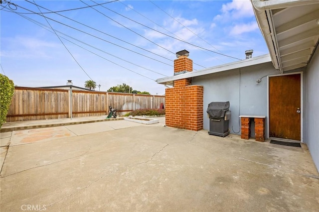 view of patio / terrace featuring fence