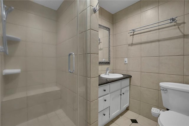 806 W 132nd St, Gardena, CA 90247 - bathroom with tile walls, toilet, a stall shower, vanity, and tile patterned floors