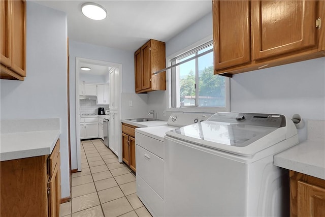 806 W 132nd St, Gardena, CA 90247 - laundry area featuring light tile patterned flooring, cabinet space, a sink, and separate washer and dryer