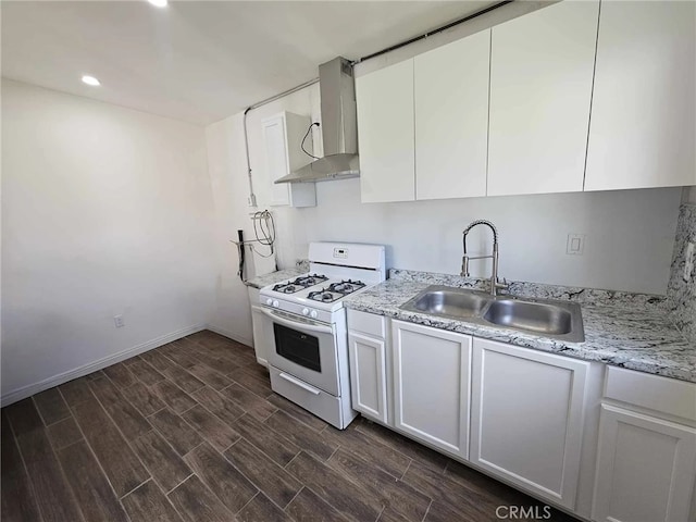806 W 132nd St, Gardena, CA 90247 - kitchen with white range with gas stovetop, a sink, white cabinetry, wall chimney range hood, and wood tiled floor