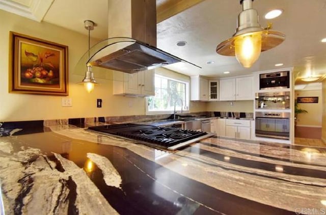 kitchen with stone counters, island exhaust hood, black gas cooktop, white cabinets, and a sink