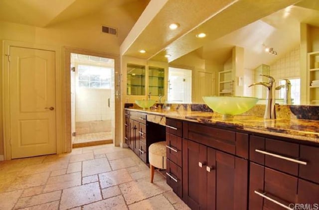 bathroom with recessed lighting, stone tile floors, visible vents, vaulted ceiling, and a shower stall