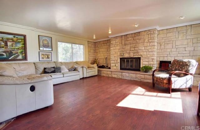 living room with ornamental molding, dark wood-type flooring, and a fireplace