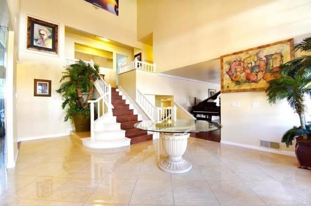 building lobby featuring stairway and visible vents