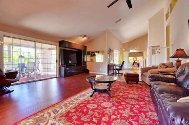 living area featuring ceiling fan, high vaulted ceiling, wood finished floors, and visible vents