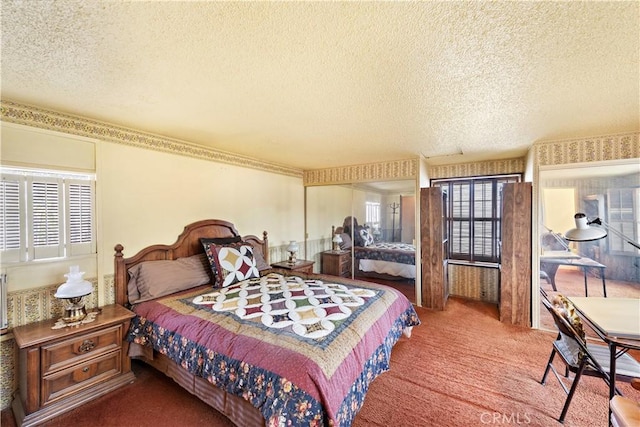 bedroom with a textured ceiling and carpet flooring