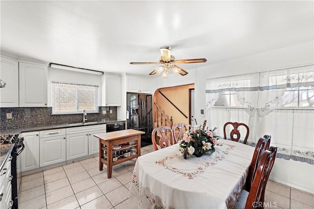 dining area with light tile patterned floors and a ceiling fan