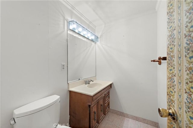 bathroom featuring ornamental molding, vanity, toilet, and baseboards