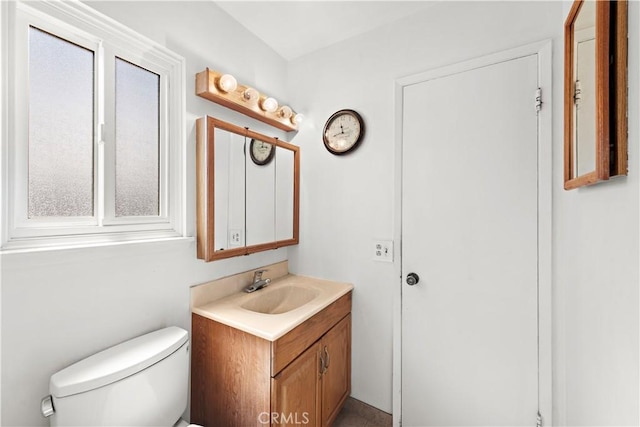 half bath featuring toilet and vanity