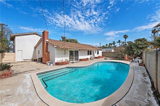 view of pool featuring a fenced in pool, a patio area, a fenced backyard, and central air condition unit