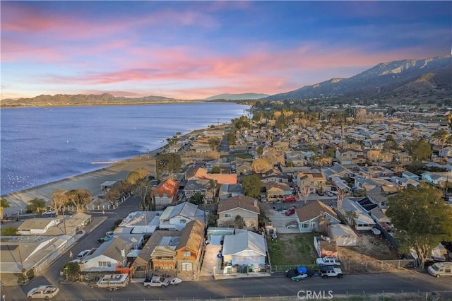 drone / aerial view with a residential view and a water and mountain view