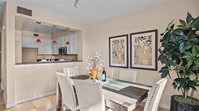 dining area featuring light tile patterned floors and visible vents