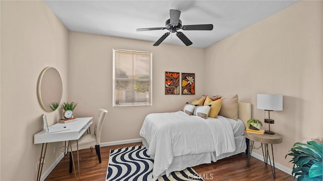 bedroom featuring ceiling fan, baseboards, and wood finished floors