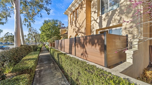 exterior space featuring fence and stucco siding