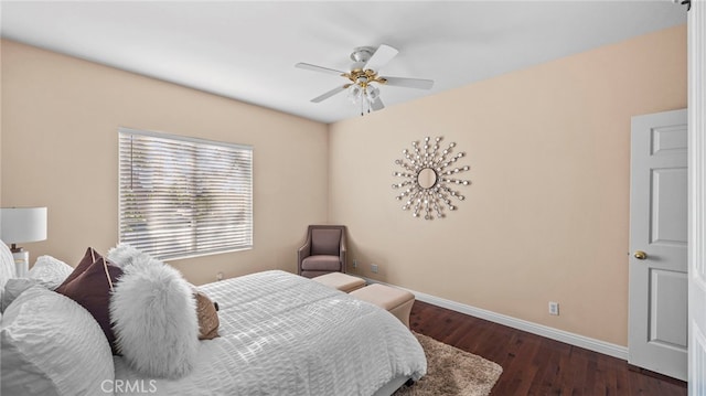 bedroom featuring ceiling fan, baseboards, and wood finished floors