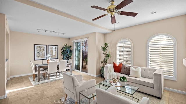 living room featuring ceiling fan, baseboards, and light tile patterned flooring