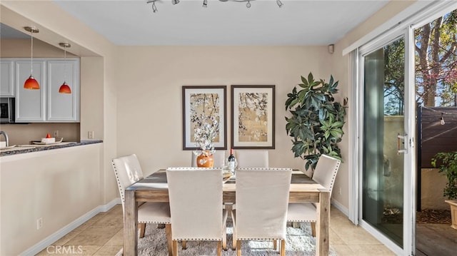 dining room with light tile patterned flooring and baseboards