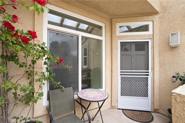 doorway to property with stucco siding