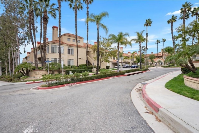 view of road with curbs, sidewalks, and a residential view