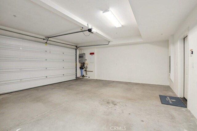 garage with electric panel and a garage door opener