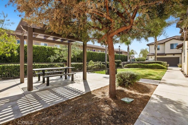 surrounding community with fence and a pergola