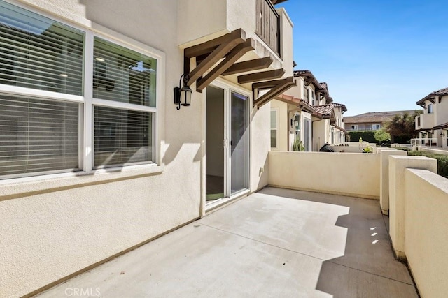 view of patio featuring a balcony and a residential view