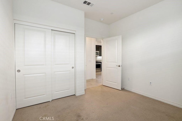 unfurnished bedroom with a closet, visible vents, and baseboards