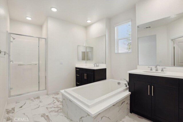 bathroom featuring a bath, a stall shower, a sink, and visible vents