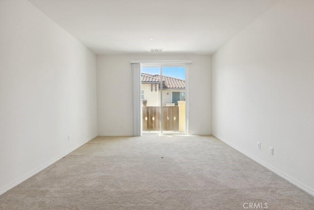 spare room with carpet flooring and baseboards