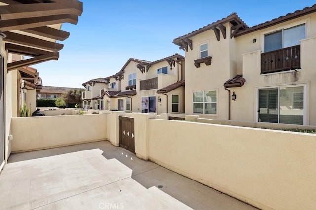 view of patio with a residential view and fence