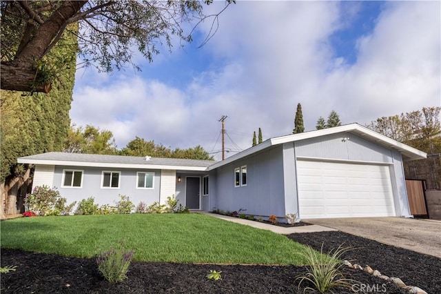 single story home featuring concrete driveway, a front lawn, and an attached garage