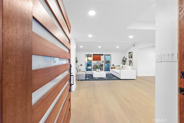 hall with recessed lighting, vaulted ceiling, and wood finished floors