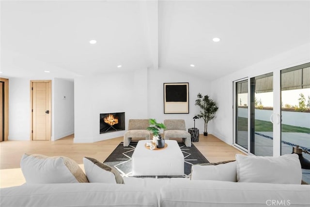 living room featuring light wood-type flooring, a warm lit fireplace, vaulted ceiling with beams, and recessed lighting