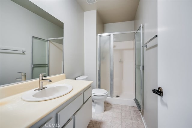 full bathroom featuring toilet, a stall shower, visible vents, and vanity