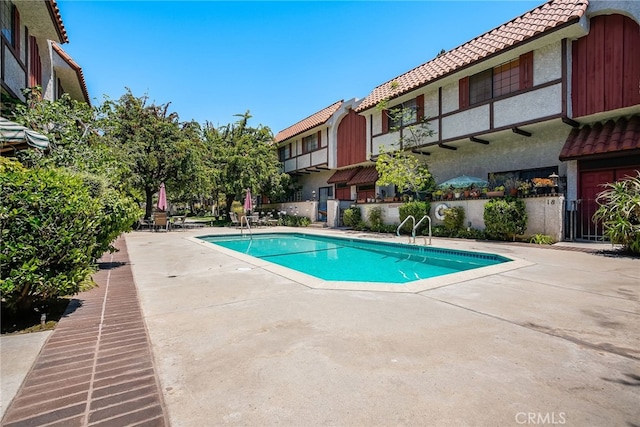 community pool featuring a patio area