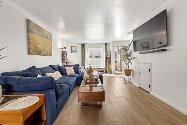 living area with wood finished floors and baseboards