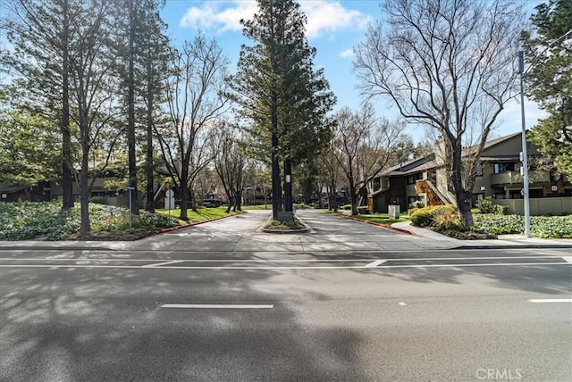 view of street with curbs and a residential view