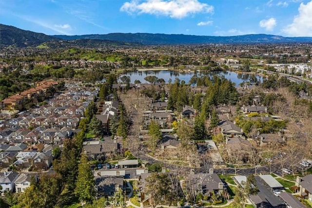 bird's eye view with a water and mountain view and a residential view