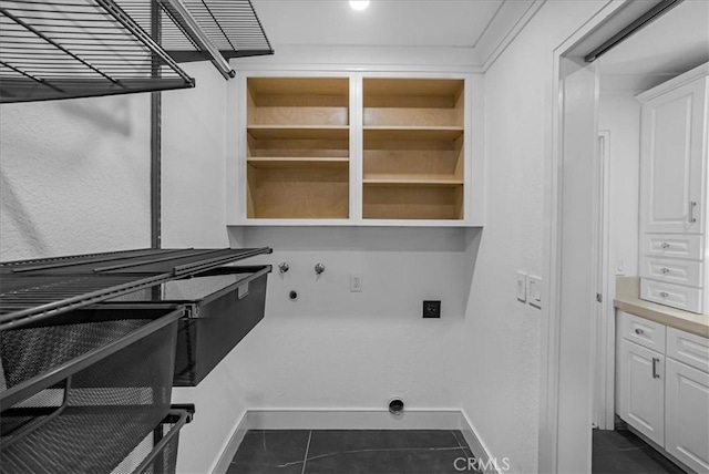 laundry room featuring dark tile patterned flooring, baseboards, laundry area, and washer hookup