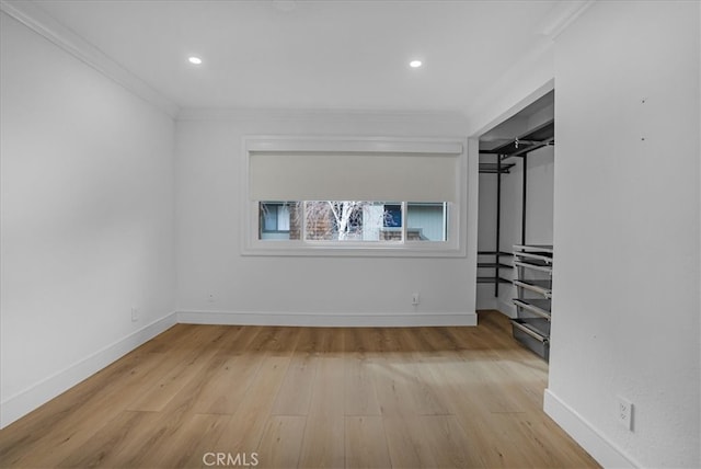 unfurnished bedroom with baseboards, wood finished floors, and crown molding