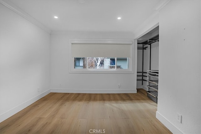 unfurnished bedroom featuring wood finished floors, baseboards, and ornamental molding